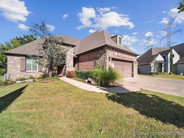 french country inspired facade featuring a garage and a front lawn