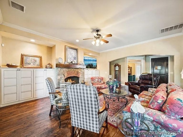 living room with ceiling fan, dark wood-type flooring, and ornamental molding