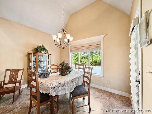 dining space featuring a notable chandelier and high vaulted ceiling