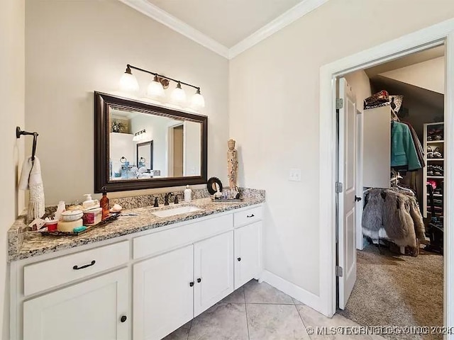 bathroom featuring tile patterned flooring, vanity, and crown molding