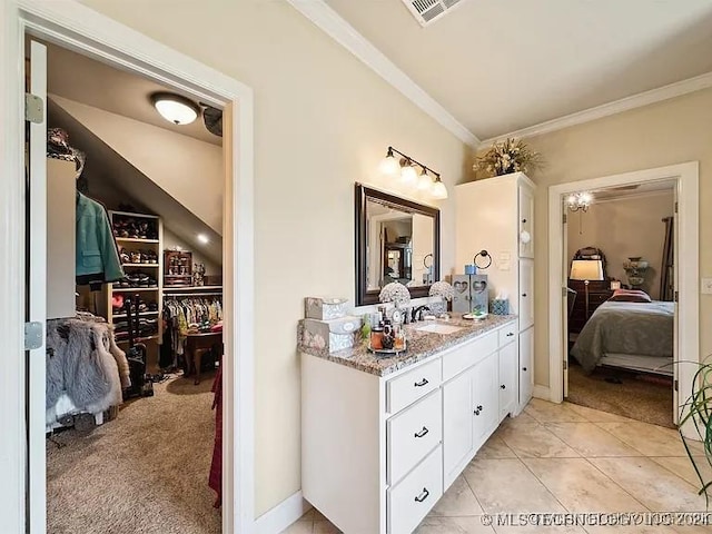 bathroom with tile patterned floors, vanity, and ornamental molding