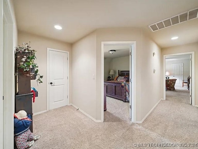 hallway with light colored carpet