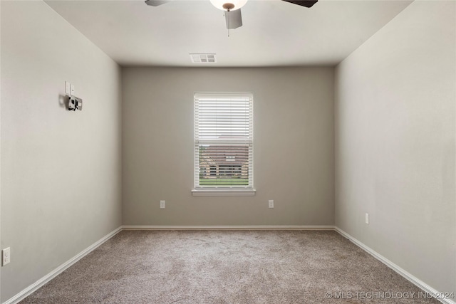 spare room with ceiling fan and carpet floors