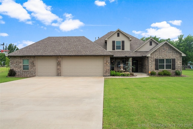 view of front of house with a front yard and a garage