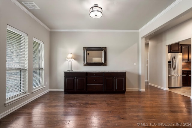 interior space featuring dark hardwood / wood-style floors, crown molding, and a healthy amount of sunlight