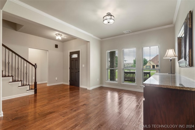 entryway featuring ornamental molding and dark wood-type flooring