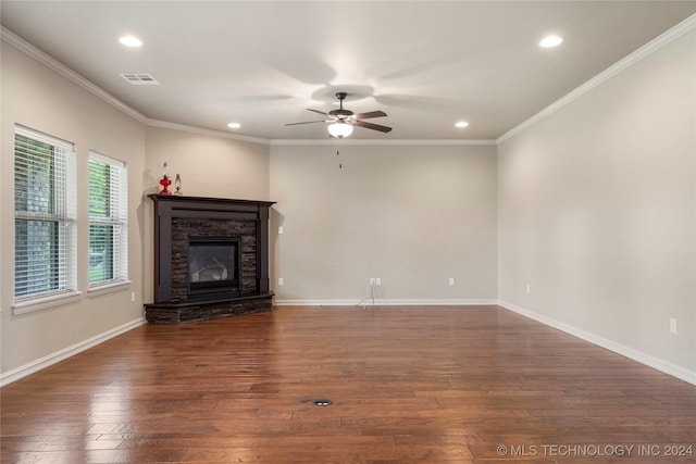 unfurnished living room featuring a fireplace, ceiling fan, dark hardwood / wood-style flooring, and crown molding