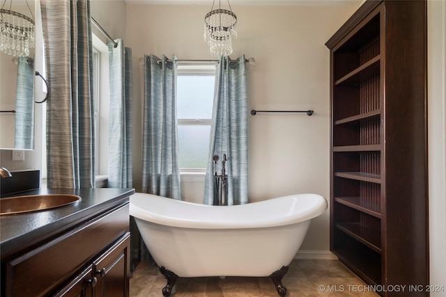 bathroom featuring tile patterned flooring, a bath, vanity, and a notable chandelier