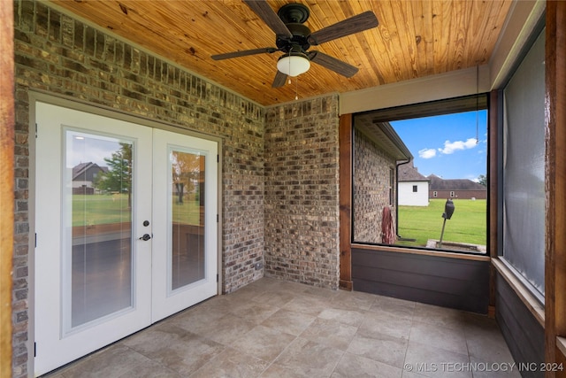 unfurnished sunroom with french doors, ceiling fan, and wooden ceiling