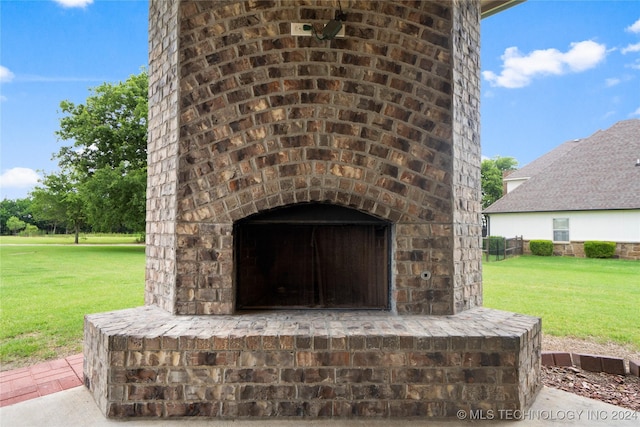 details featuring an outdoor brick fireplace