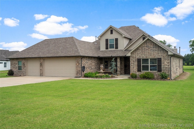 view of front of home with a garage and a front lawn