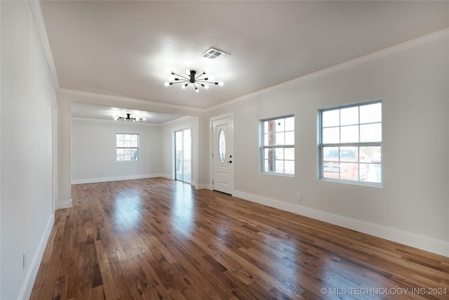 entryway featuring wood-type flooring, an inviting chandelier, and ornamental molding