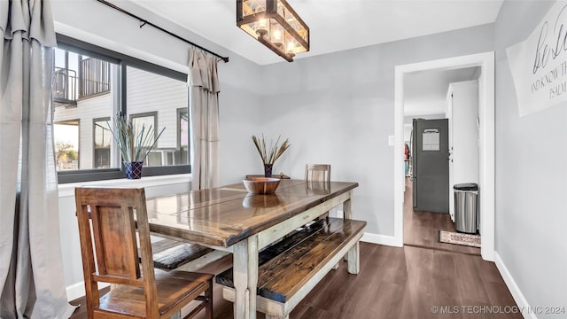 dining area featuring dark wood-type flooring