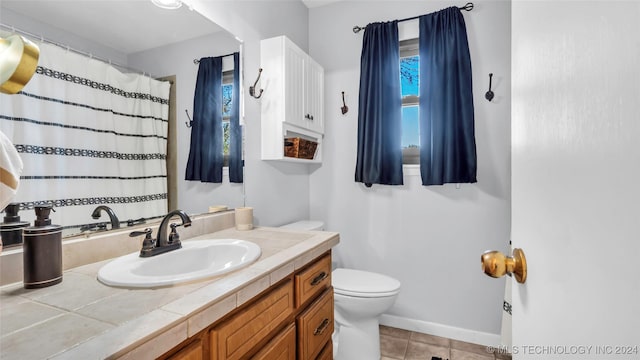 bathroom featuring tile patterned flooring, vanity, and toilet