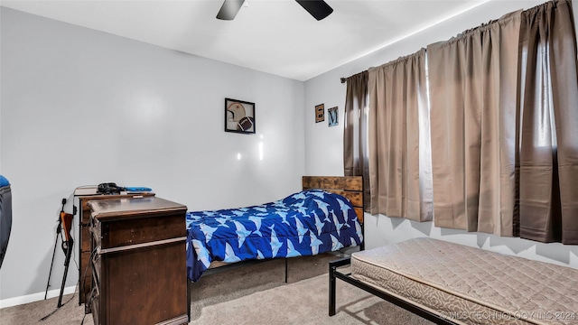 bedroom featuring ceiling fan and light carpet