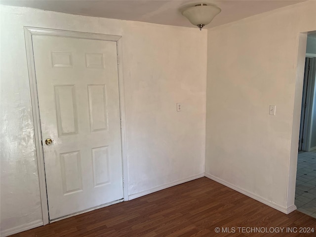 empty room featuring dark hardwood / wood-style flooring