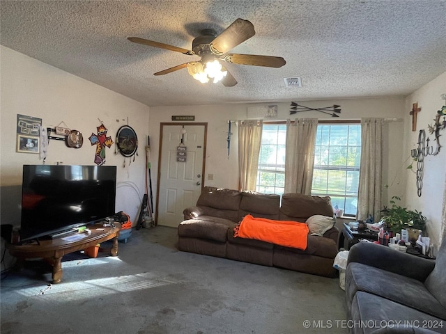 carpeted living room featuring a textured ceiling and ceiling fan