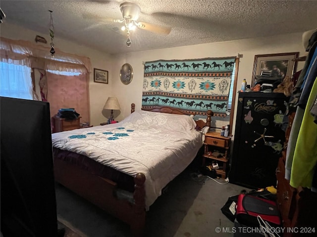 carpeted bedroom featuring a textured ceiling and ceiling fan