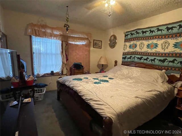 bedroom with carpet floors and a textured ceiling