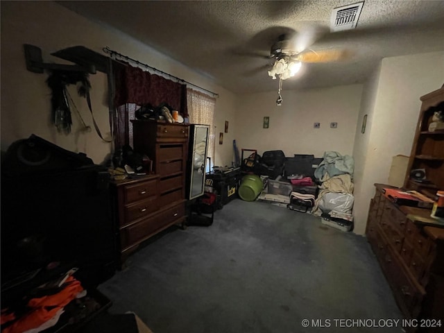 bedroom featuring ceiling fan, carpet floors, and a textured ceiling