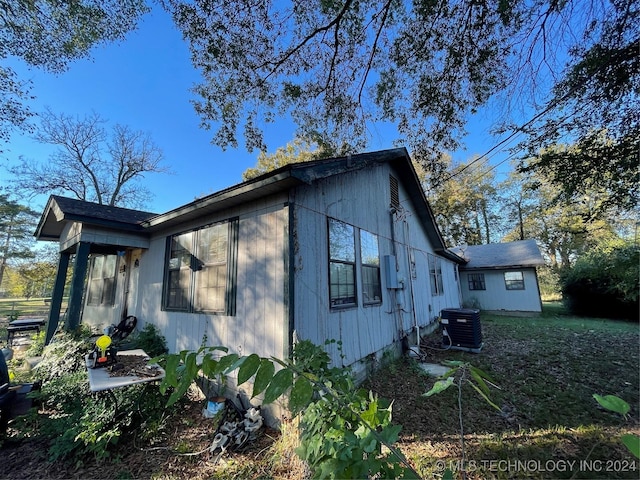 view of side of property with cooling unit