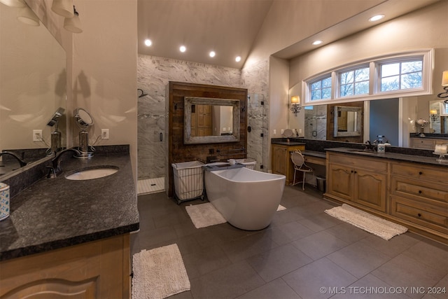 bathroom with tile patterned flooring, vanity, tile walls, and plus walk in shower