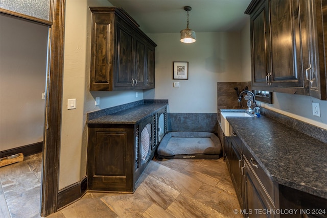 kitchen featuring dark brown cabinets, pendant lighting, and sink