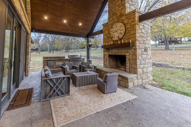 view of patio / terrace with an outdoor living space with a fireplace, area for grilling, and grilling area