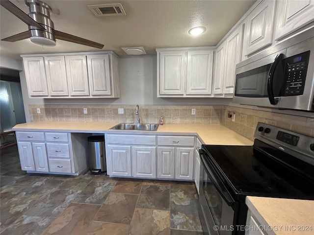 kitchen with white cabinets, sink, and stainless steel appliances