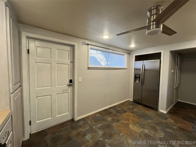 kitchen with white cabinets, stainless steel refrigerator with ice dispenser, a textured ceiling, and ceiling fan