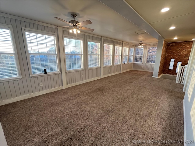 unfurnished sunroom with ceiling fan