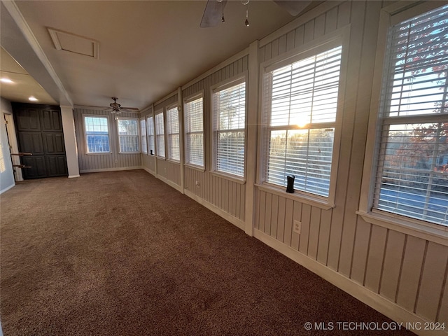 unfurnished sunroom with ceiling fan and a healthy amount of sunlight