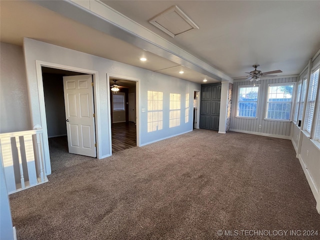 unfurnished room with carpet, ceiling fan, and beam ceiling