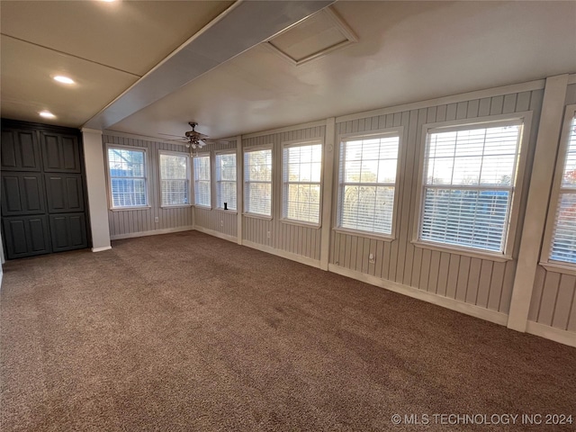 unfurnished sunroom with ceiling fan