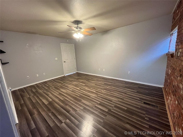 spare room with ceiling fan and dark wood-type flooring