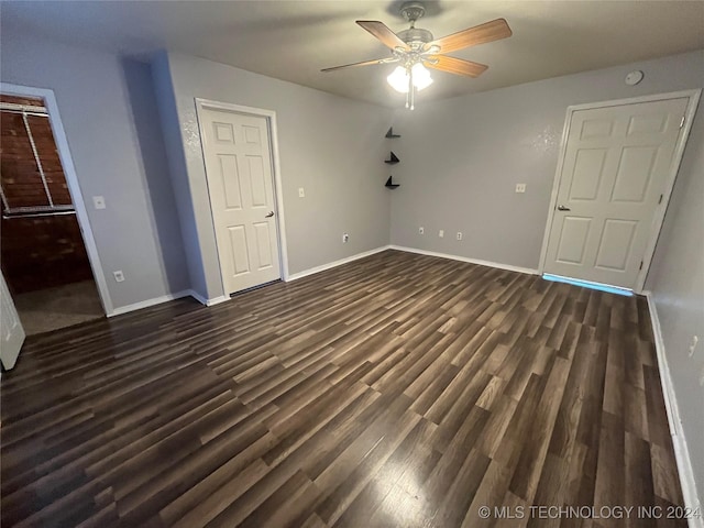 unfurnished bedroom with ceiling fan and dark hardwood / wood-style flooring