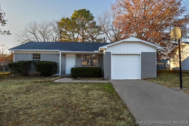 ranch-style home with a front lawn and a garage