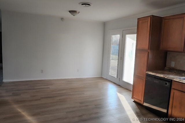 kitchen with hardwood / wood-style floors, ornamental molding, and black dishwasher