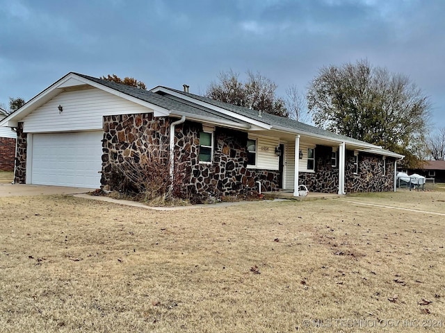 ranch-style home with a garage and a front lawn