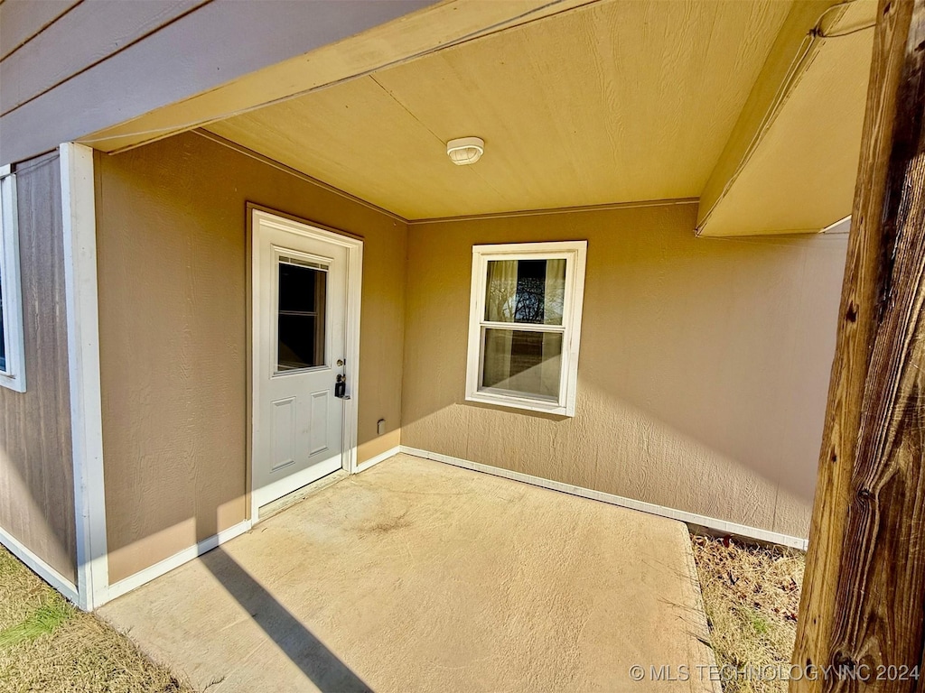 view of exterior entry featuring a patio