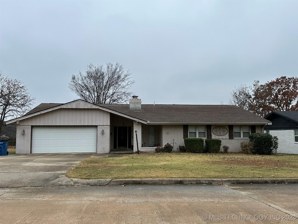 ranch-style house with a front yard and a garage