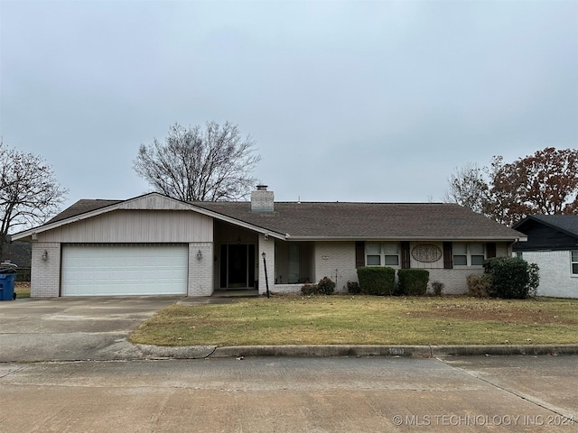 ranch-style house with a front yard and a garage