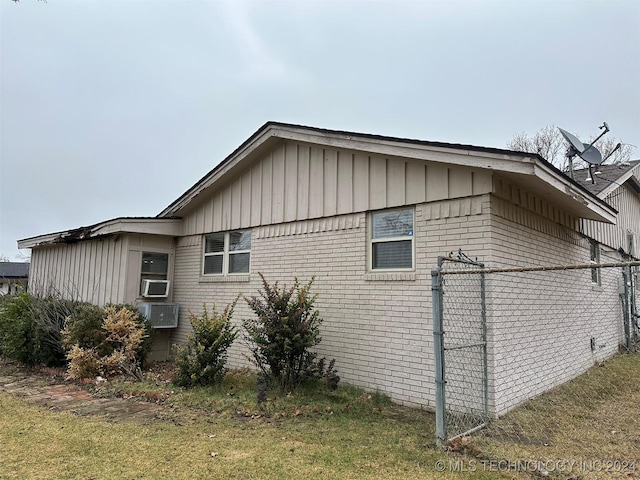 view of home's exterior with a lawn and cooling unit