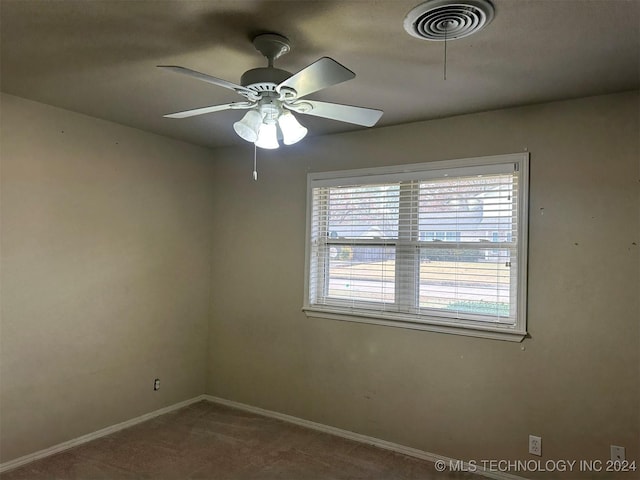 carpeted empty room featuring ceiling fan and a wealth of natural light