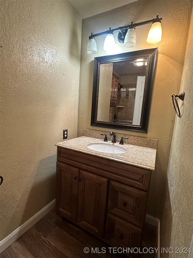 bathroom with wood-type flooring and vanity