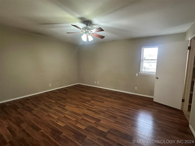 spare room featuring dark hardwood / wood-style floors and ceiling fan