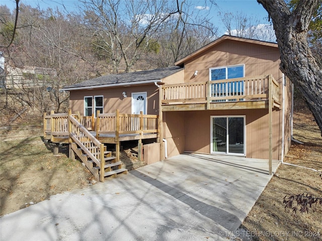 rear view of property with a patio and a wooden deck