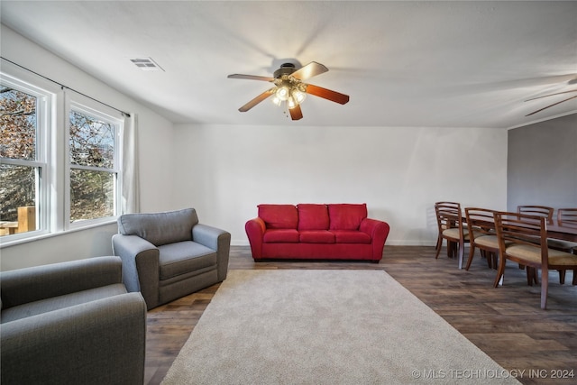 living room featuring dark hardwood / wood-style flooring and ceiling fan