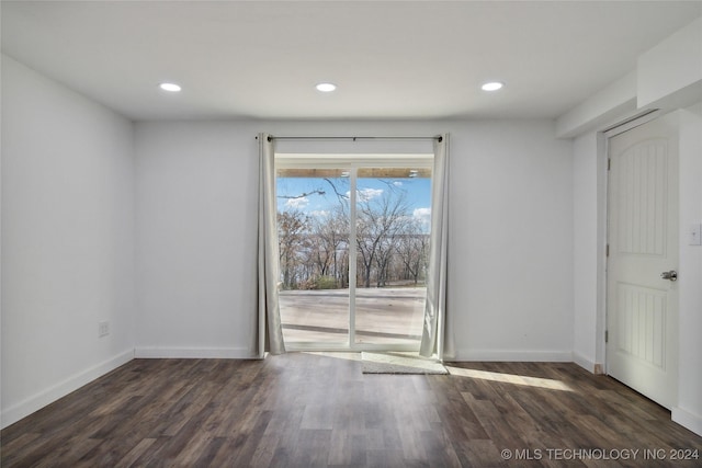 spare room with dark hardwood / wood-style flooring