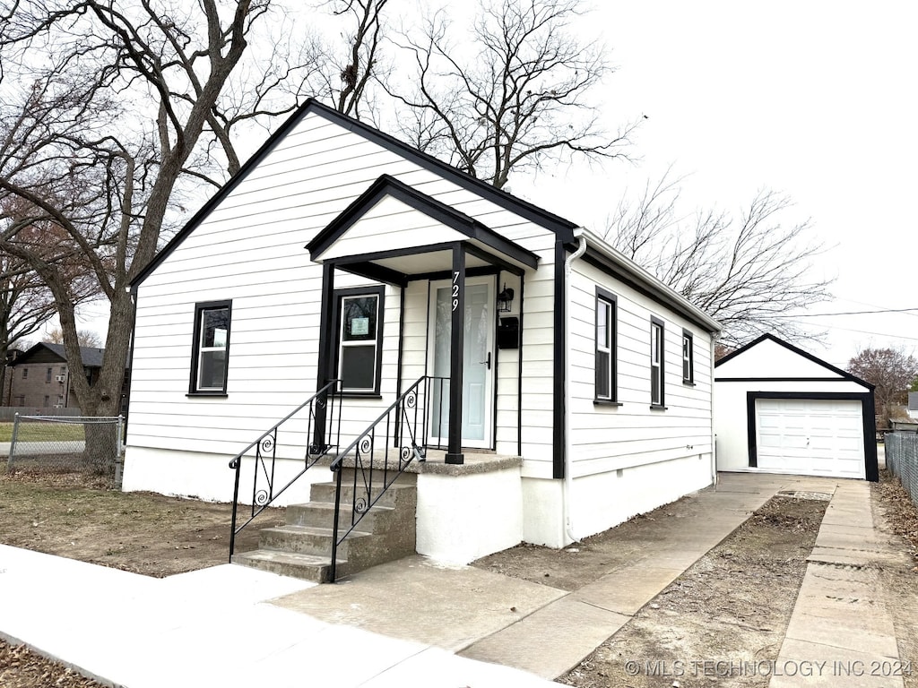 view of front of house featuring a garage and an outdoor structure